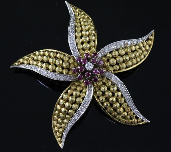 An 18ct gold, ruby and diamond set flower head pendant brooch, gross 18 grams.
